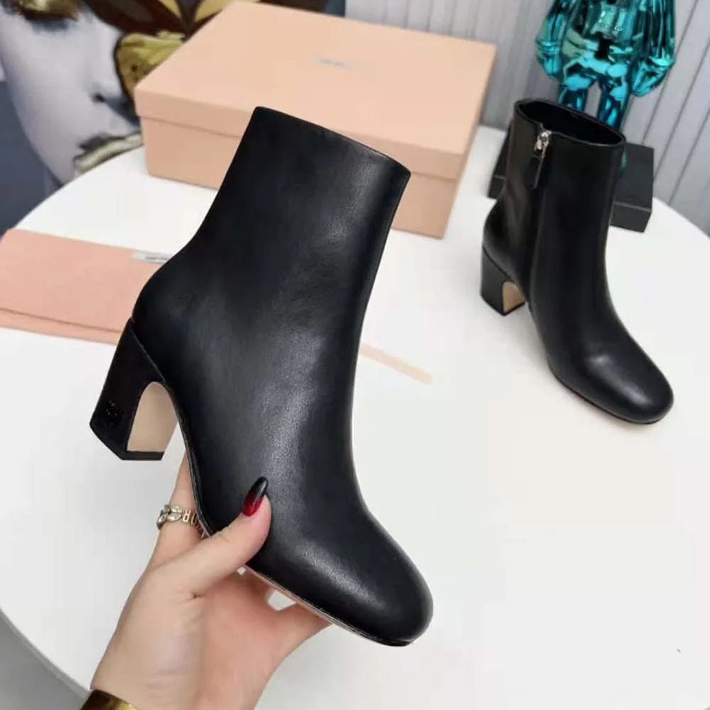 Miu Miu Leather Booties with Metal Lettering Logo for Women in Black